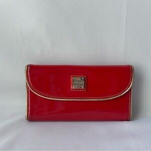 Dooney & Bourke patent continental Leather cluth with gold accents